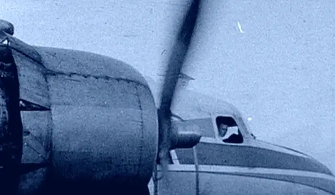 propeller plane with pilot looking out window