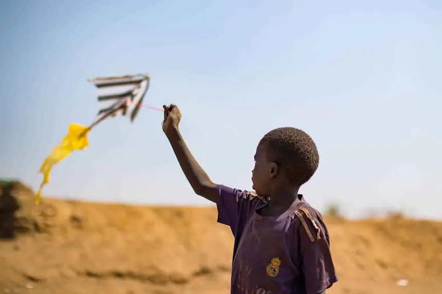 A boy flies a kite in a protection of civilians (POC) site in Juba, South Sudan.