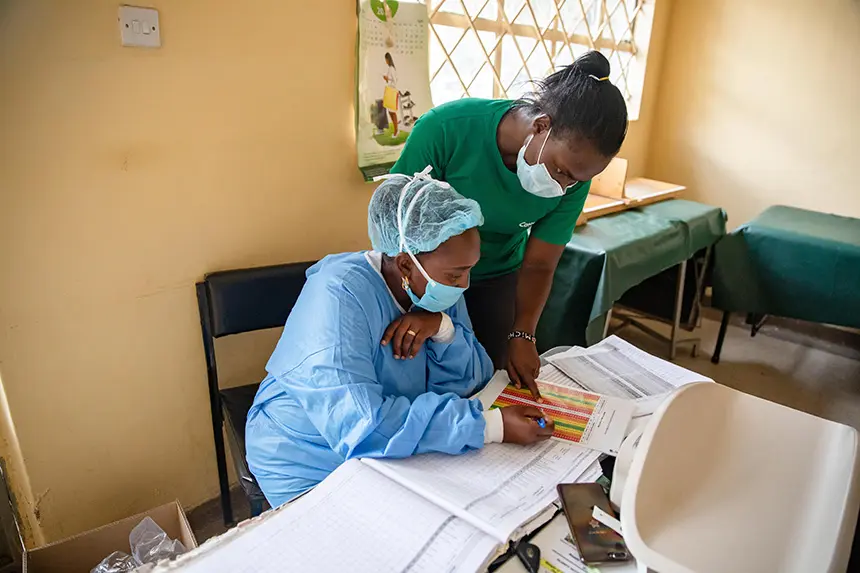 Staff consult charts at a nutrition clinic