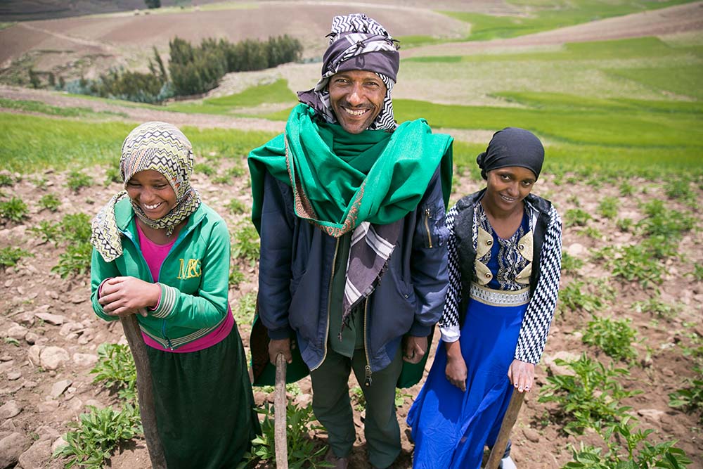 Ali Assen Ali, with two of his daughters, on their potato farm