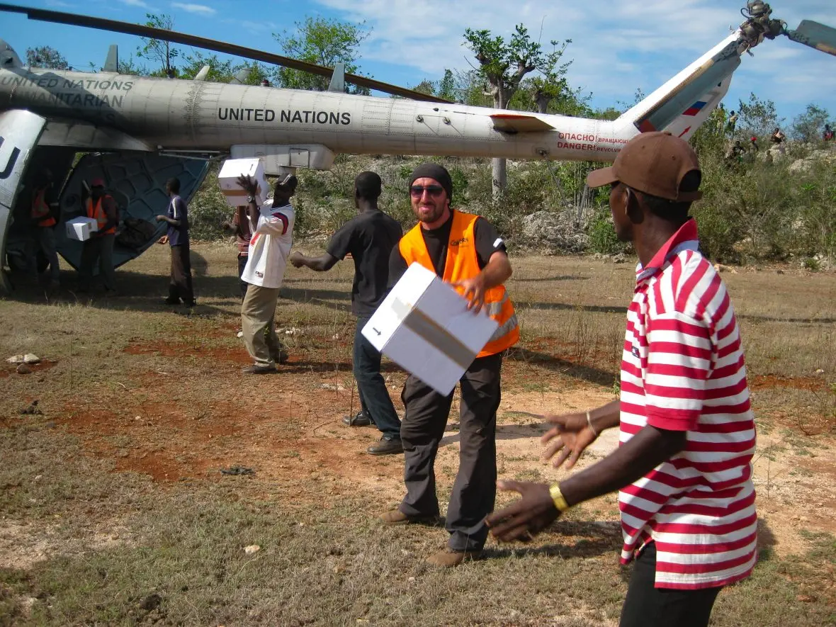 People unload cargo from a plane.