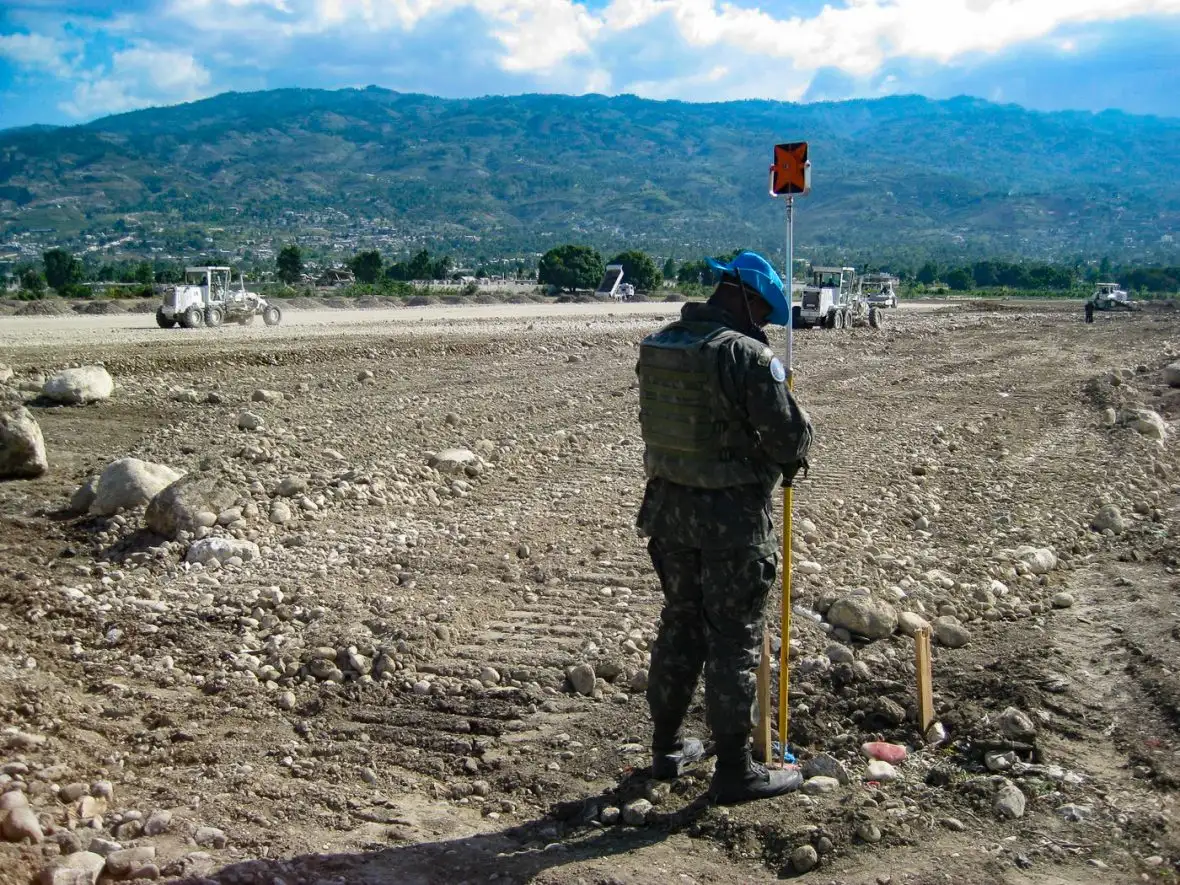 A man standing in an open area outside.