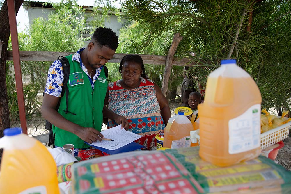 a concern staff member with a market vendor in Haiti