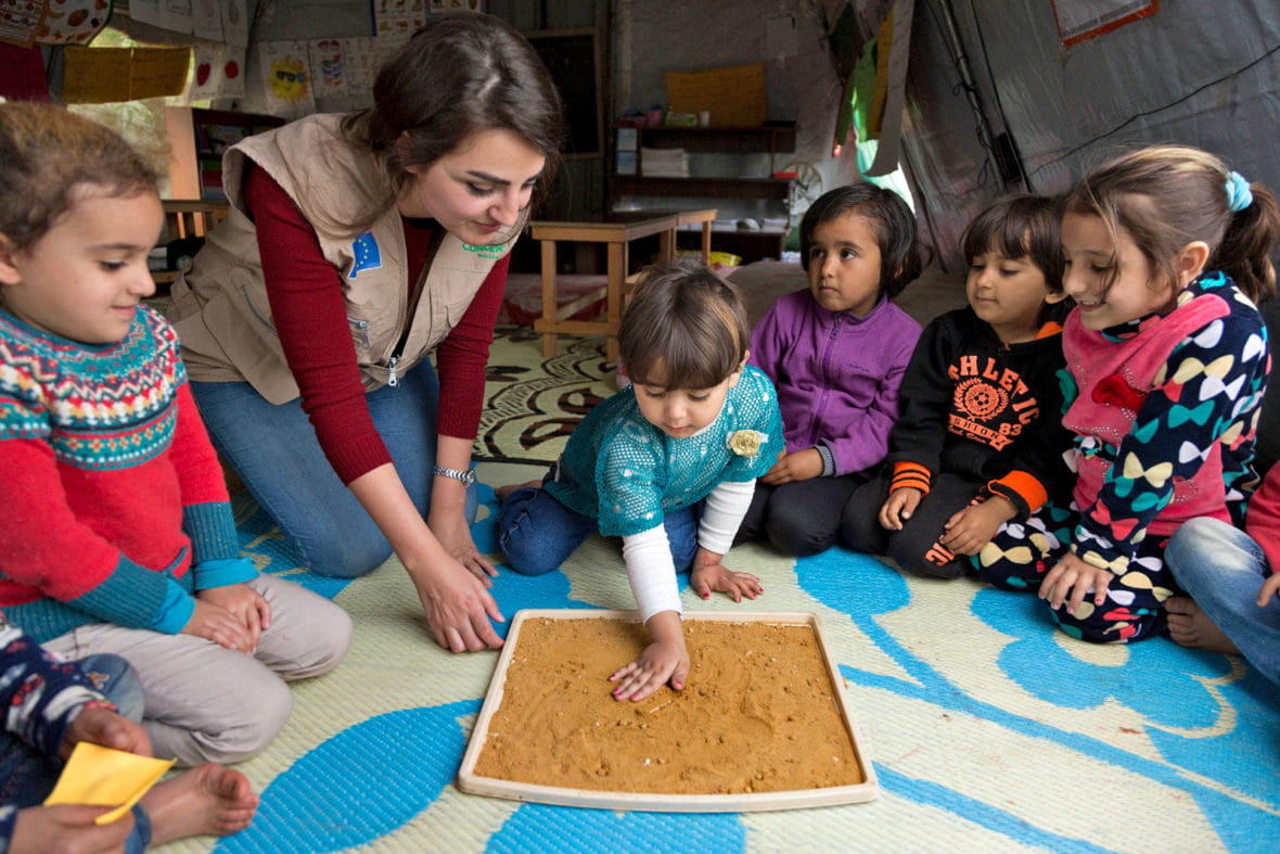 Concern Worldwide education officer, Nour Al Hajal, with a group of children attending a non-formal education program that focuses on early childhood education in northern Lebanon.