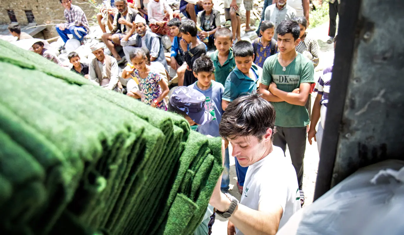 Concern’s Kirk Prichard unloads carpets for a distribution in Talamarang, a village in Sindhupalchok district.