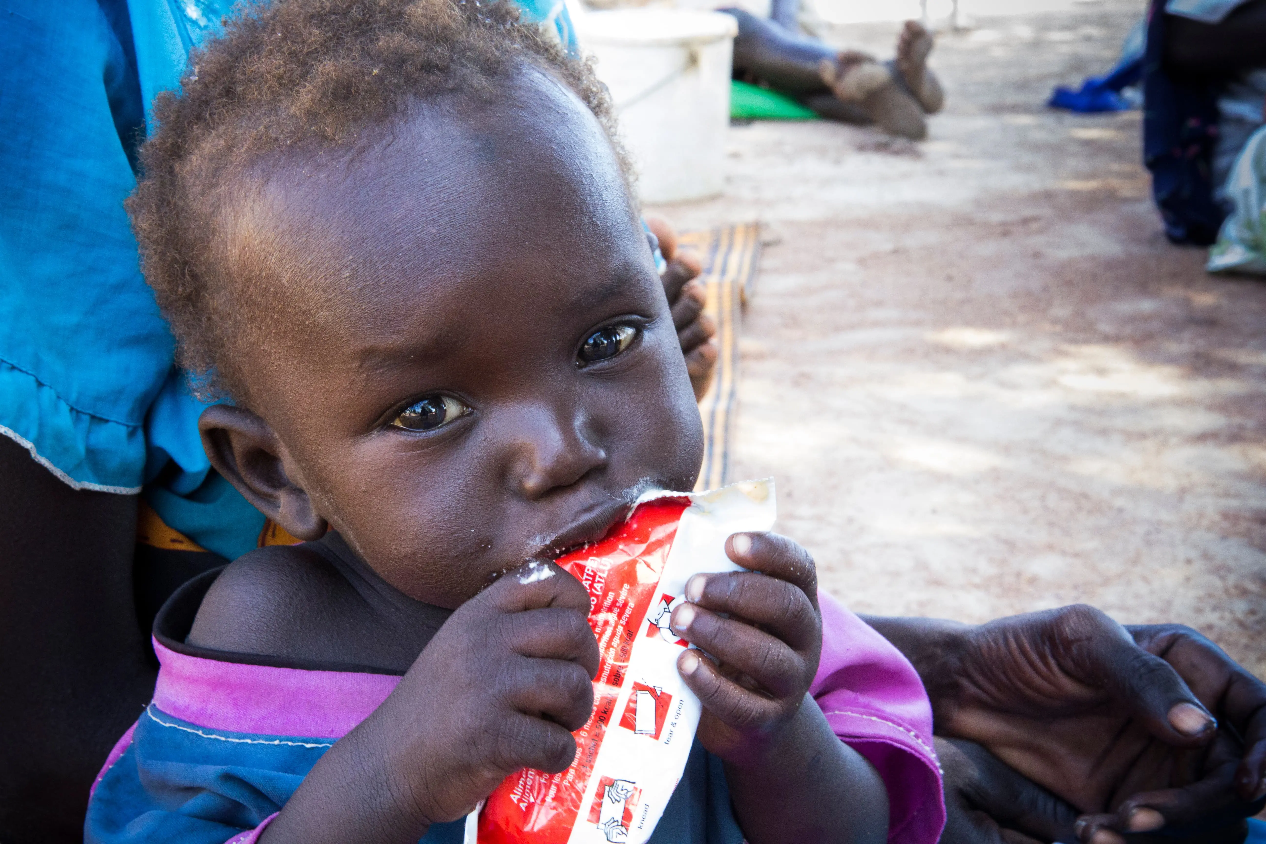 Small child eating from packet