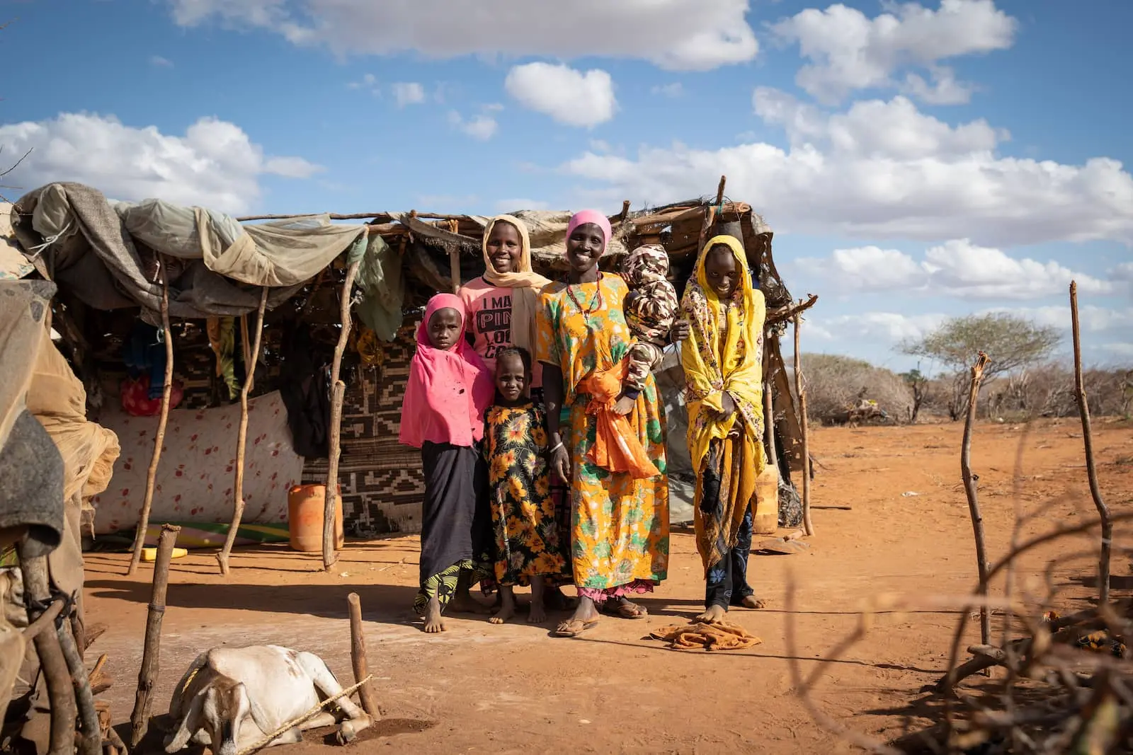 Mumina Mohamed poses for a photograph with her five children outside her home in Subo village. Mumina participated in Concern Worldwide’s Lifesaving Education and Assistance to Farmers (LEAF) project in Tana River County, Kenya. The program helped address climate change through resilient agricultural methods, and centered women farmers in the process. (Photo: Lisa Murray/Concern Worldwide)