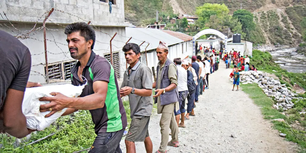 Supplies are unloaded at a Rural Reconstruction Nepal (RRN) and Concern Worldwide distribution in Talamarang, Sindhupalchok district, Nepal