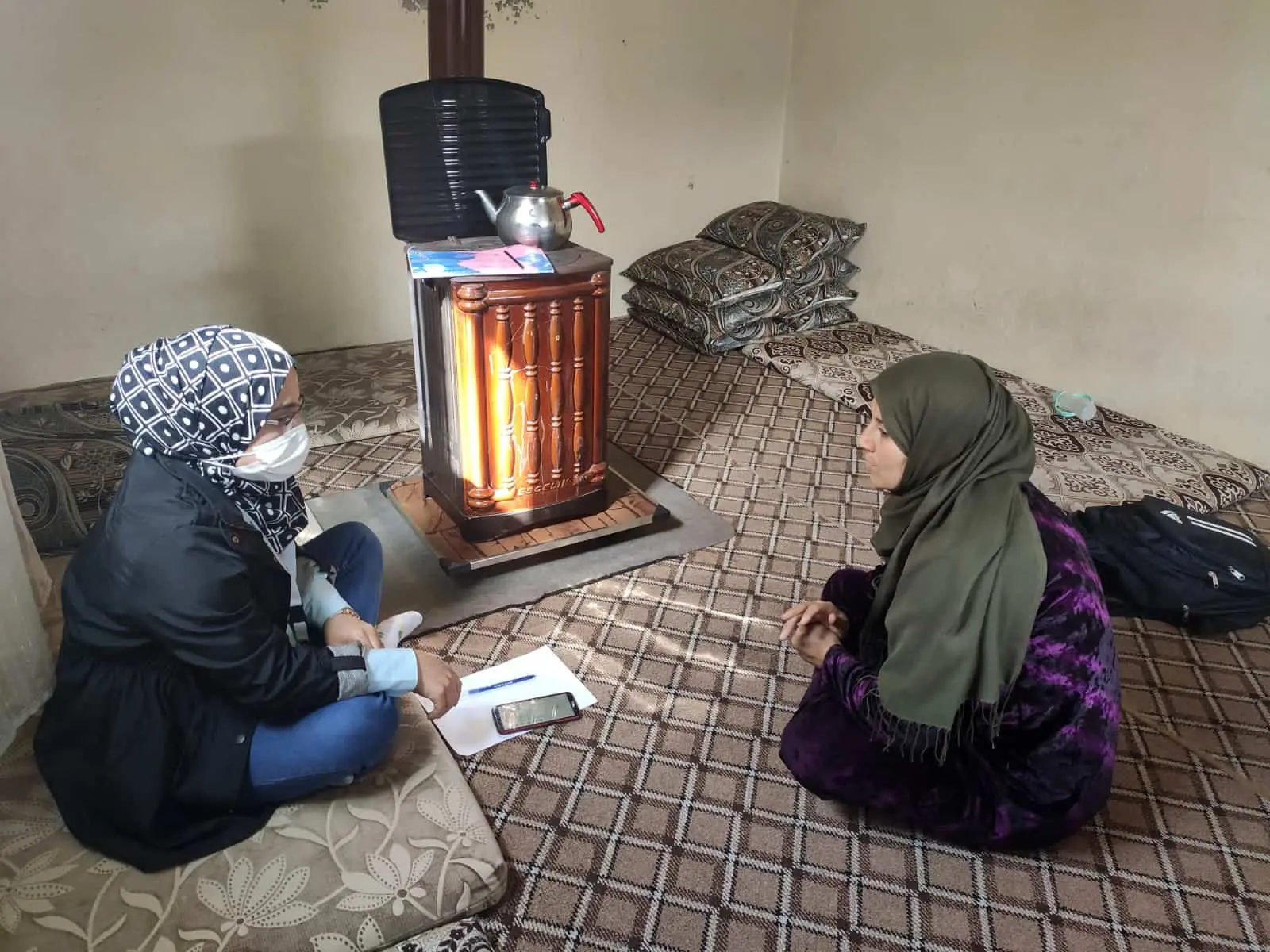 Syrian woman talking in refugee shelter