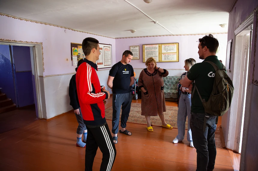 Concern Program Manager Charlie Acland meets with a family displaced by war from their home in the Donbas. They are living in a college dormitory in the rural west of the country. (Photo: Kieran McConville / Concern Worldwide)