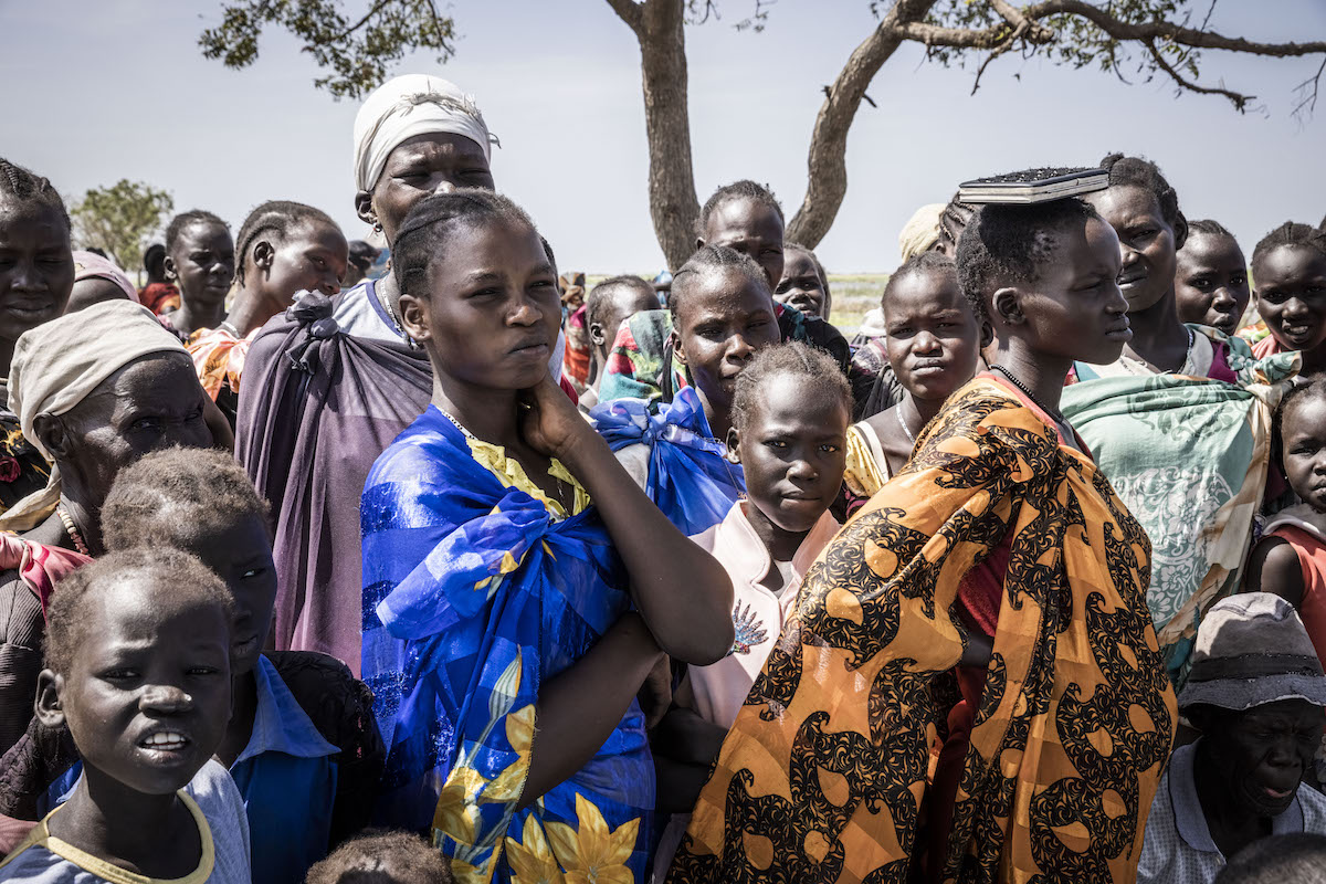 People wait for a cash distribution in Chotyiel, a settlement surrounded by flood water near Gwit, south of Bentiu in Unity State. (Photo: Ed Ram/Concern Worldwide)