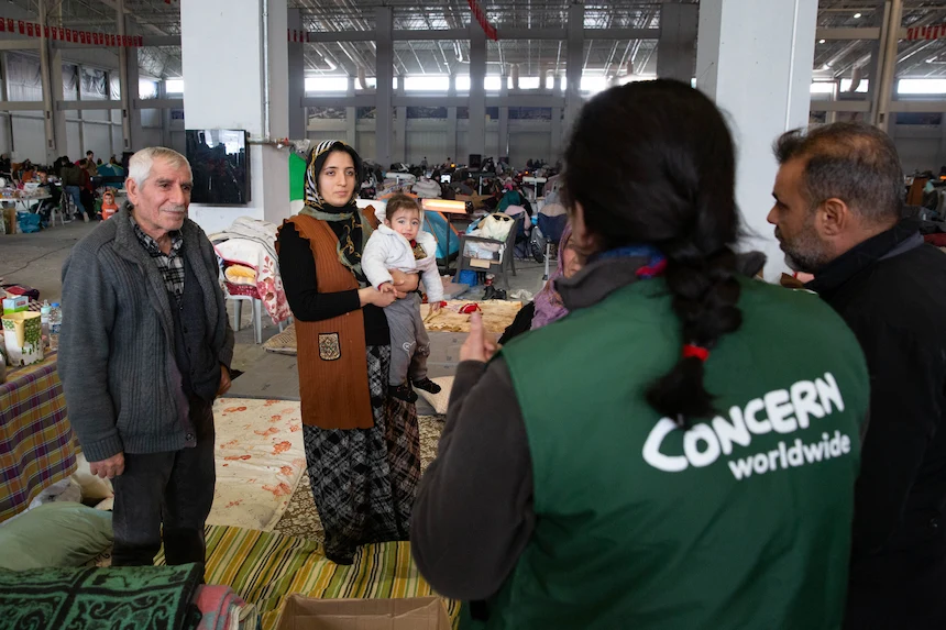 Family at communal shelter with Concern worker after 2023 Turkey earthquake