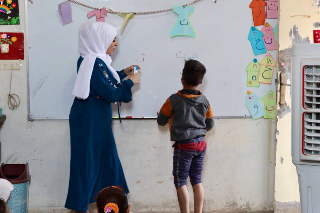 Despite the tough times, Hani loves going to school. He learns, plays with friends, and really enjoys reading. (Photo: Ahmad Hbood/Concern Worldwide)