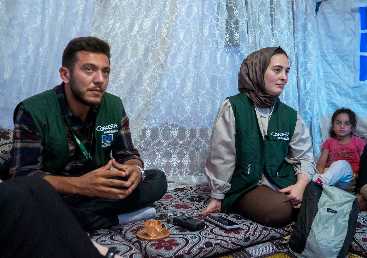 Concern staff Mustafa Al Aryan and Hatice Firat visit Darine* and her family. (Photo: Gavin Douglas/Concern Worldwide)