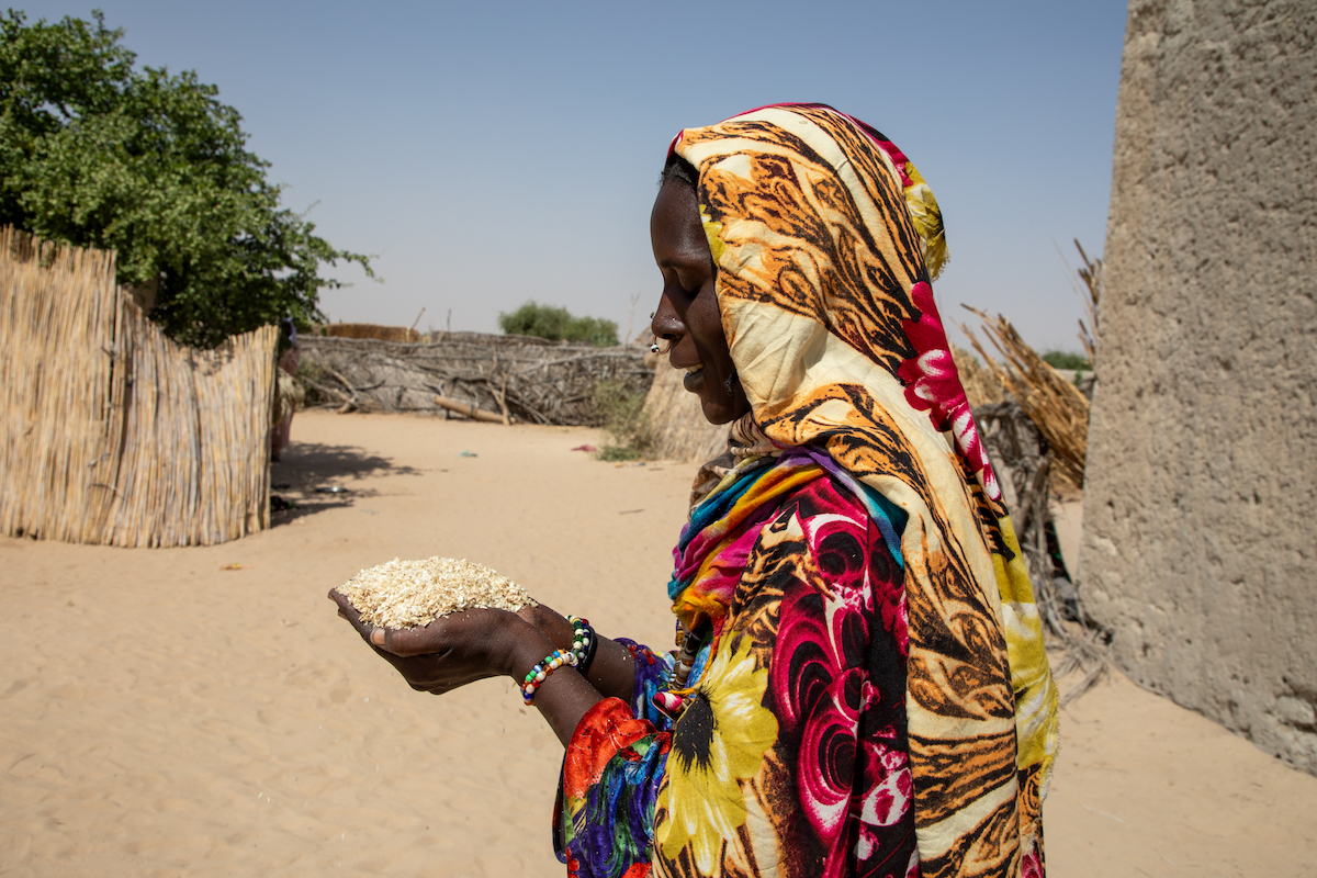 Sala Gana Ali showcases some of the millet bran she feeds her goats at her home in Ndjati village, Baga Sola. Photo: Eugene Ikua/Concern Worldwide