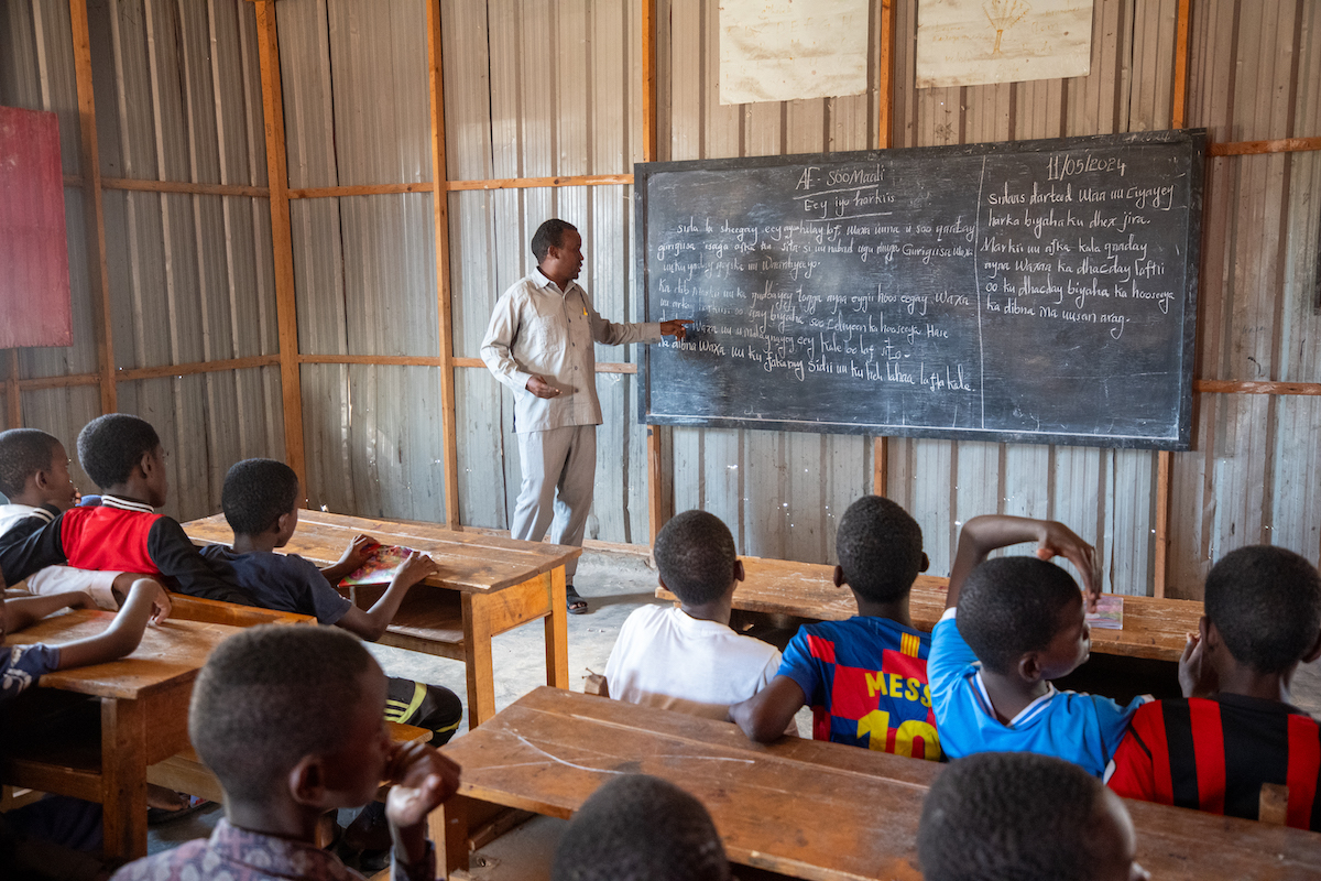 Anas* teaches at Tokyo school which is located in an Internally displaced camp and supported by Concern. Anas* recalls how the people in the camp had issues with reading whenever they get phone messages or papers but now that the children attend classes they help adults read. (Photo: Mustafa Saeed/Concern Worldwide)