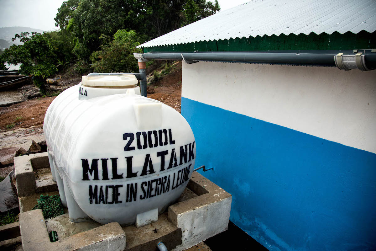 A rainwater catchment system fills a water tank on the community latrine built by Concern Worldwide in the east of Freetown, Sierra Leone (Photo: Michael Duff)