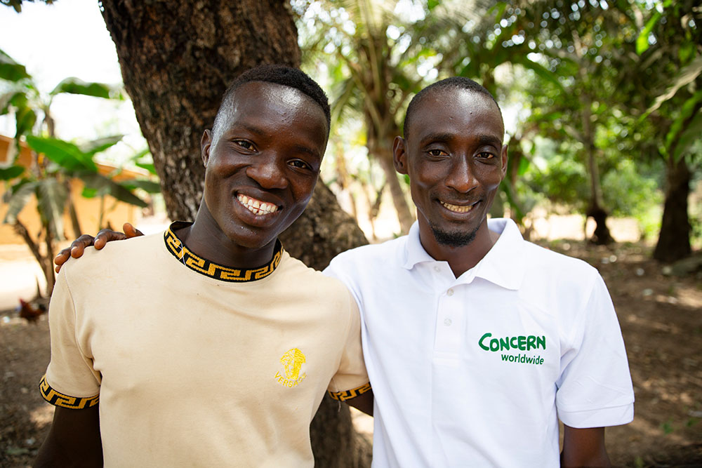 Concern staff member with community member in Sierra Leone