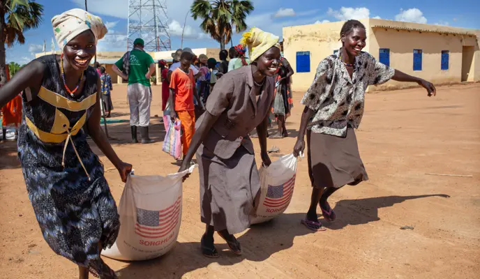 Women collect food rations from a Concern Worldwide and World Vision food distribution in the Aweil area, South Sudan. The general food distribution occurs every two weeks, running from April to August.