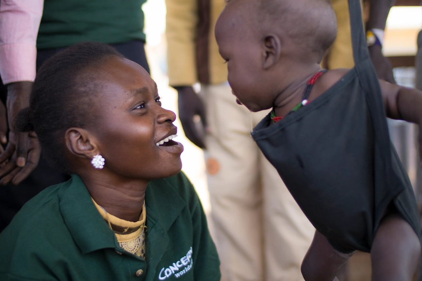 Concern staff member with a young child in SoutSudan