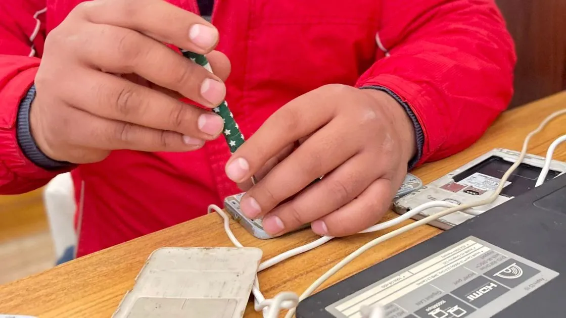 man fixing mobile phone