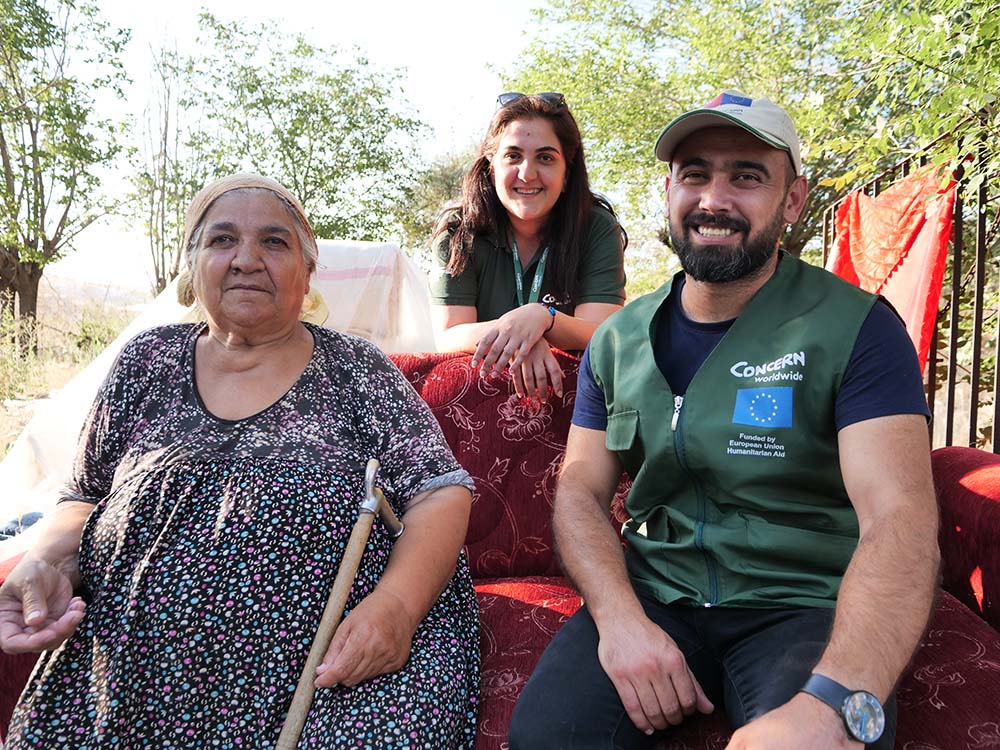 Concern Worldwide staff with a woman affected bye the 2023 earthquake