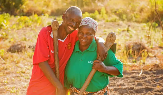 Chibala and Catherine posing for the photo and working together in their field.