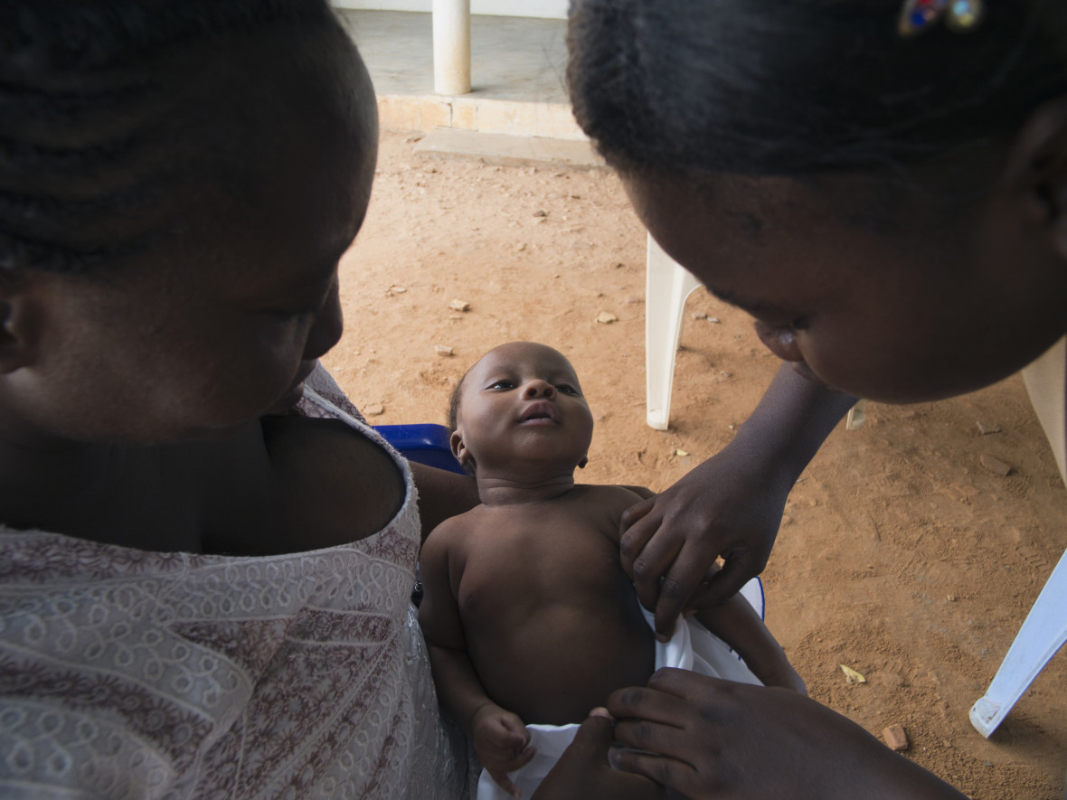 Nurse examines newborn's umbilical stump