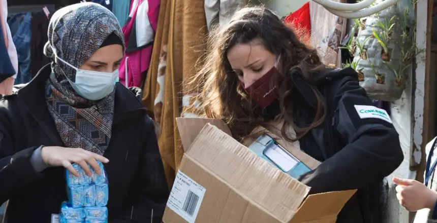 Team members of Concern distribute soap at an informal tented settlement in north Lebanon.