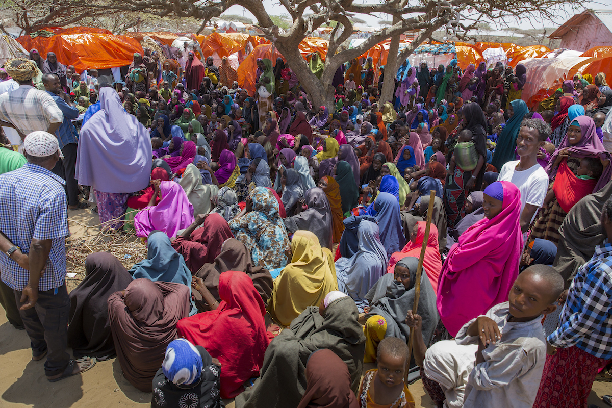 Displaced families collect SIM cards for emergency cash phone transfers from Concern Worldwide at a displacement camp in Mogadishu, Somalia. The programme is funded by DIFD. Numbers of people being displaced by drought and hunger are increasing steadily