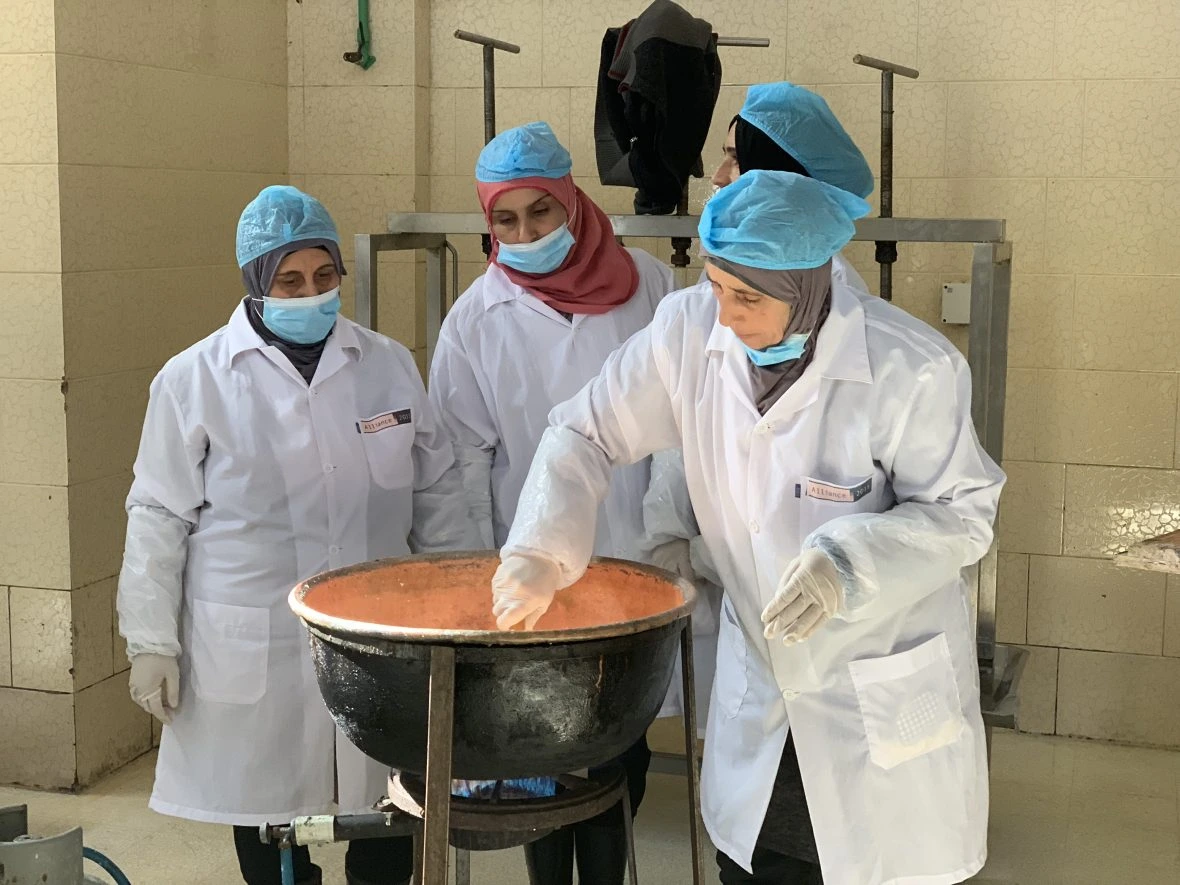 Khadija and fellow Syrian refugees take part in a training session of dairy production in Northern Lebanon.