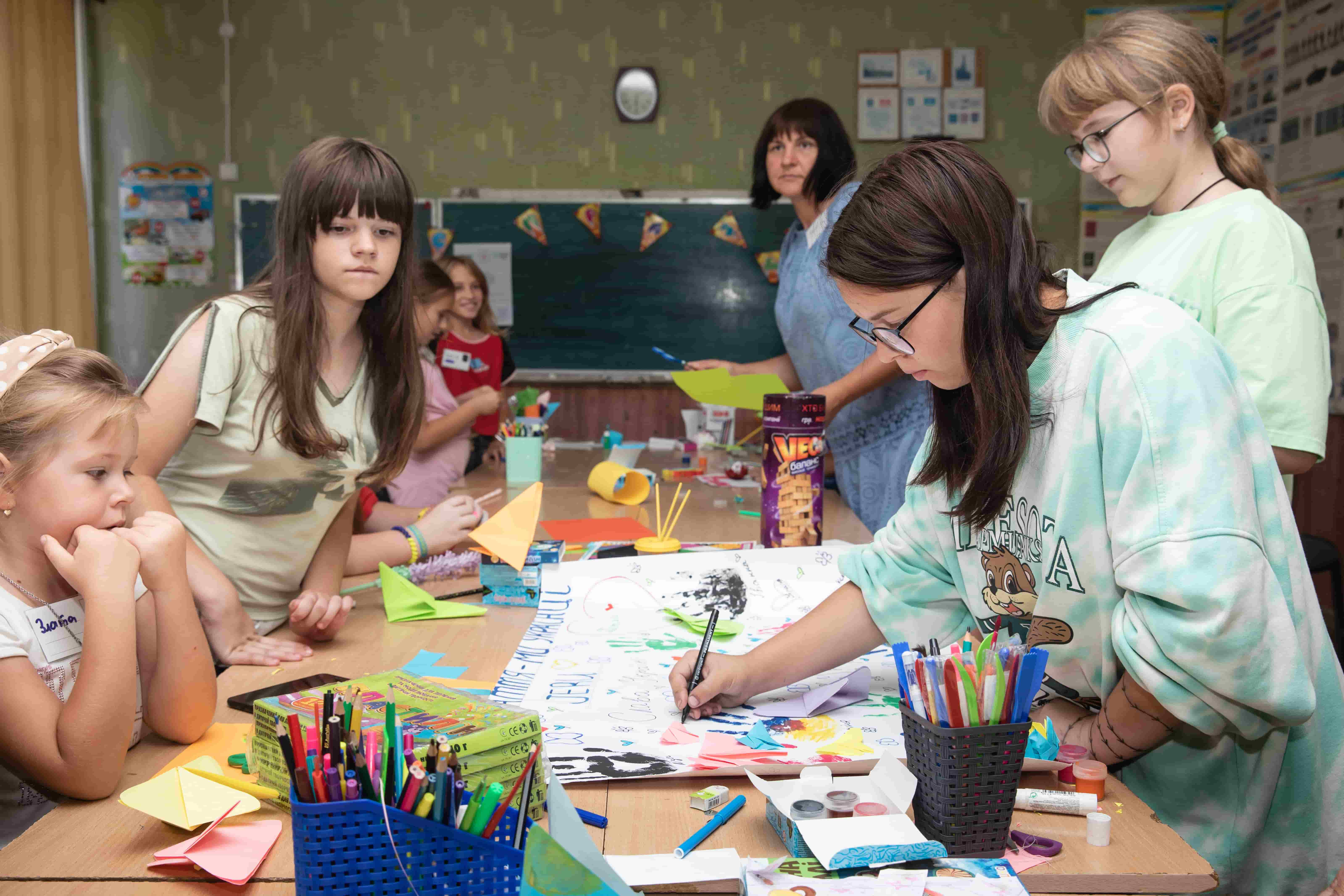 Children coloring at a table