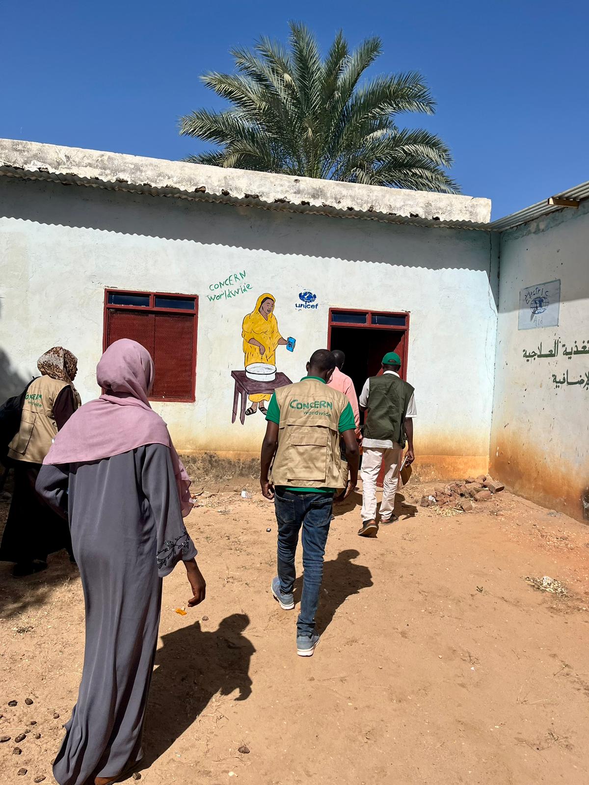 Concern's team walking into a UNICEF and Concern-supported health facility in Sudan.